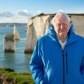 David Attenborough stands at the coast in Southern England. (Credit: Silverback Films and Open Planet Studios/Keith Scholey)